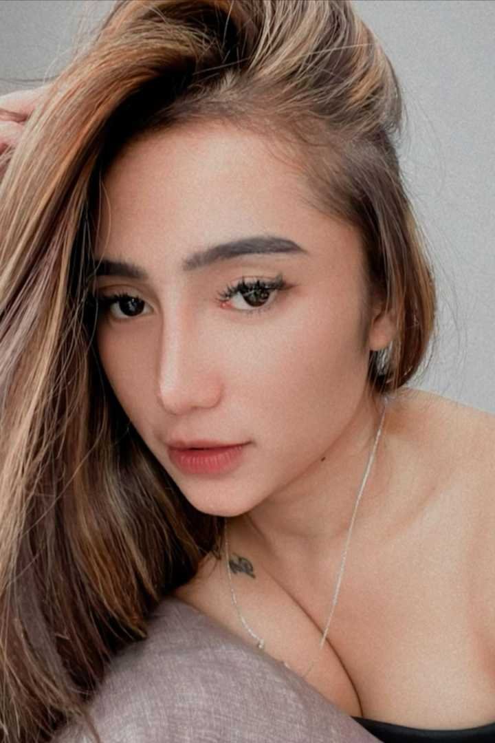 Portrait of a young woman with long brown hair.