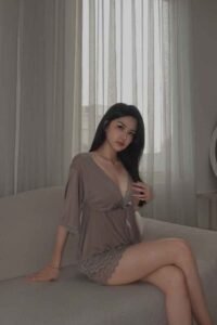 Woman in a taupe silk robe and shorts