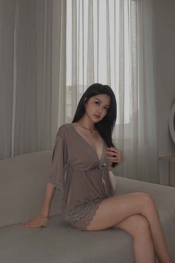 Woman in a taupe silk robe and shorts