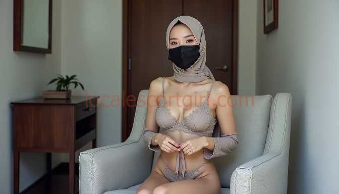 Woman in hijab and mask wearing lingerie, seated in armchair